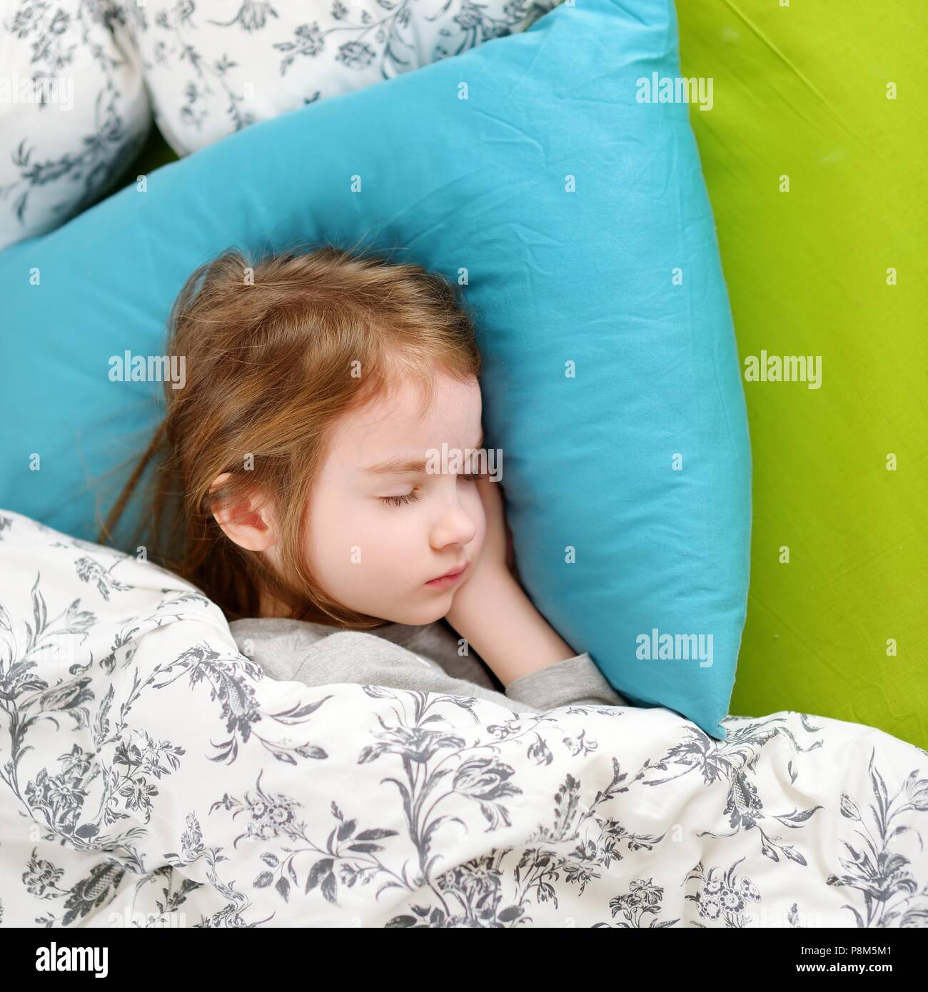Adorable little girl sleeping in a bed Stock Photo - Alamy