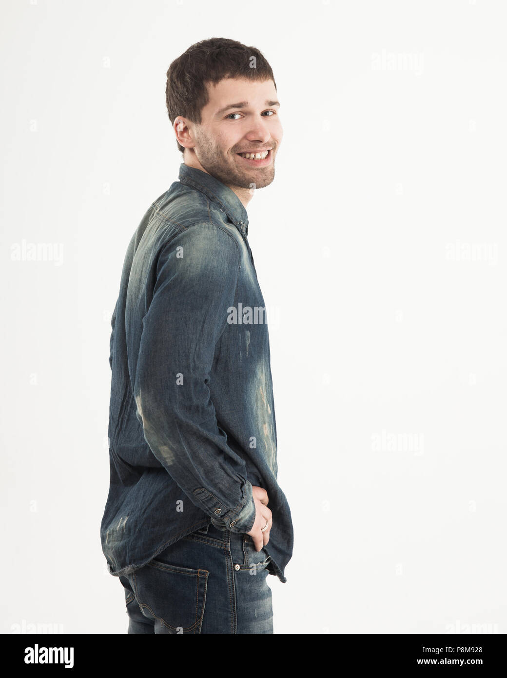 side view of smiling stylish young guy is looking forward to the Stock Photo