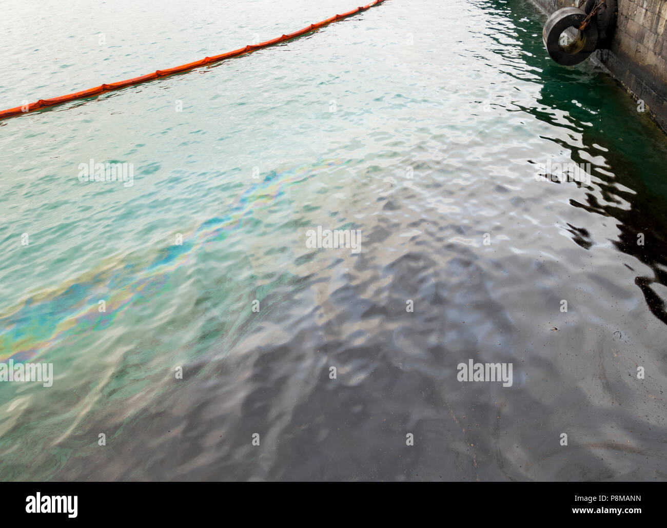 Oil spill containment boom containing oil spill in harbour Stock Photo Alamy