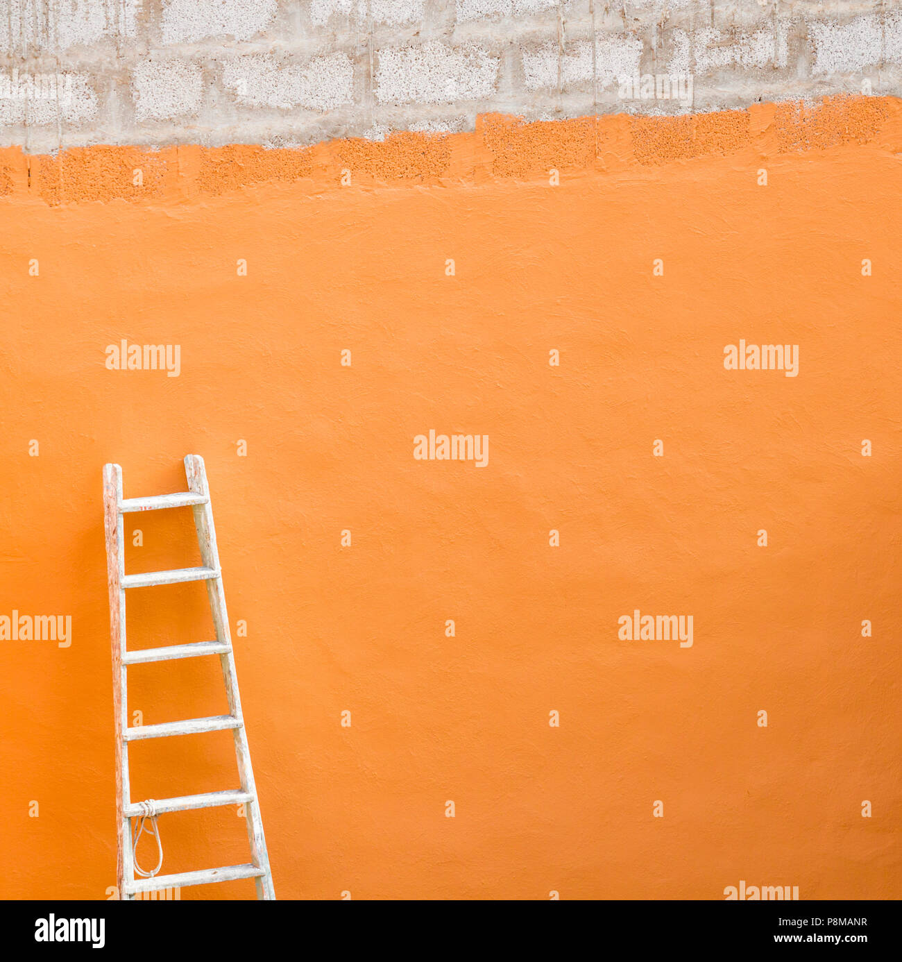 Wooden ladder against wall Stock Photo