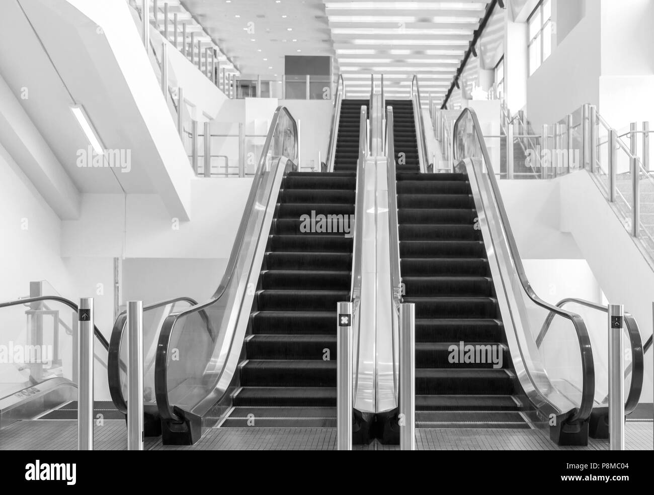 View of empty escalator in shopping mall. Black and white tone. Stock Photo