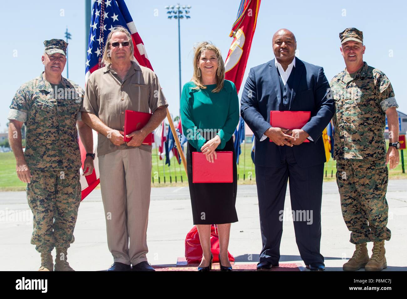 U.S. Marine Corps Brig. Gen. Kevin J. Killea, far right, commanding general, Marine Corps Installations West (MCI-W) and Sgt. Maj. Julio E. Meza, far left, sergeant major, MCI-W, take a photo with recipients of the Federal Length of Service Award at Marine Corps Base Camp Pendleton, California, June 26, 2018, June 26, 2018. Killea and Meza awarded the civilians to respect and honor their 30 years of faithful service. (U.S. Marine Corps photo by Pfc. Stephen Beard). () Stock Photo