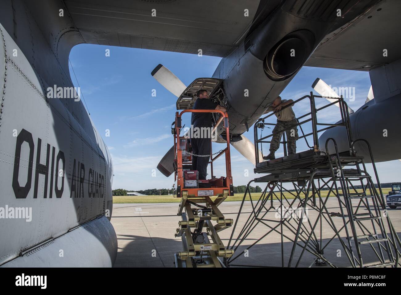 Senior Airman Tim Johnson and Senior Airman Hunter Mitchell, Aerospace Propulsion Specialist, 179th Airlift Wing Maintenance Group, evaluates an engine of the C-130H Hercules while it is running June 26, 2018, at the 179th Airlift Wing, Mansfield, Ohio, June 26, 2018. The diagnostic test requires the engine to be running for the Airman to properly identify the cause of this particular issue and is also known by aircraft mechanics as 'Man on the stand'. (U.S. Air National Guard photo by Capt. Paul Stennett/Released). () Stock Photo
