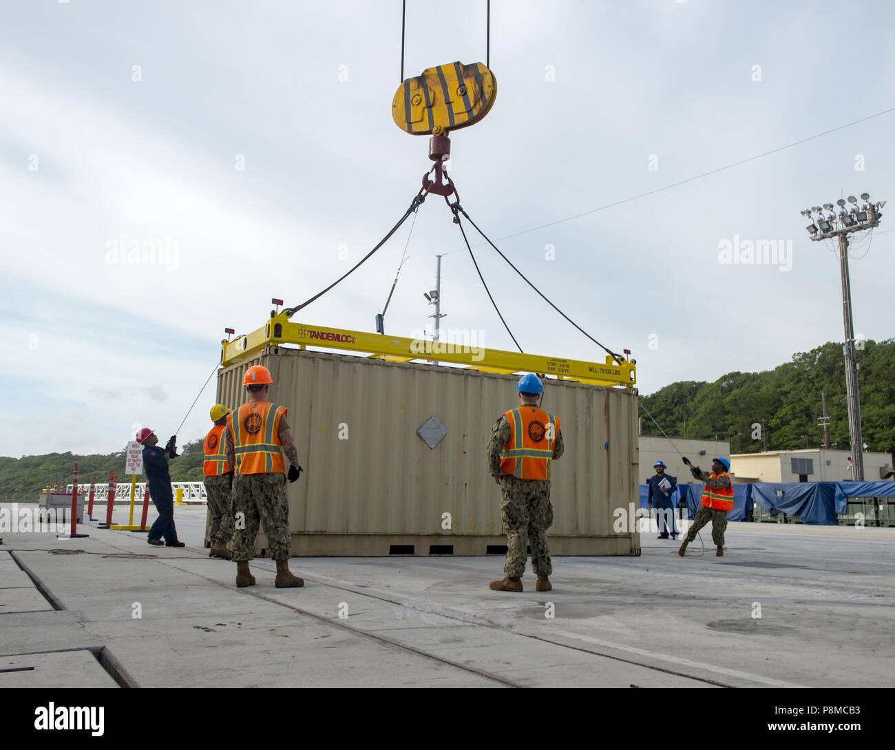 Sailors assigned to Navy Cargo Handling Battalion (NCHB) 1, Det, July 2, 2018. Guam, on load ammo cans to a cargo ship at Naval Base Guam, July 2, 2018. NCHB 1 Det. Guam, assigned to Commander, Task Force 75, is the Navy's only active duty cargo handling battalion, and is a rapidly deployable operating unit of the Navy Expeditionary Combat Command, capable of loading and discharging ships and aircraft in all climatic and threat conditions. (U.S. Navy photo by Mass Communication Specialist 3rd Class Kryzentia Richards). () Stock Photo