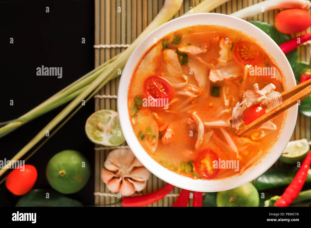 Tom Yum Gai or spicy tom yum soup with chicken - Authentic Thai style food. With ingredients: lemongrass, galangal, kaffir lime leaves, fresh chilies, Stock Photo