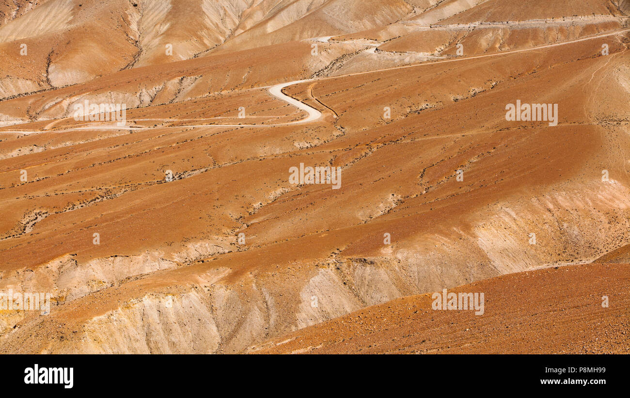 Abstract impression of eroded landscape with dirt road in the Atacama desert Stock Photo
