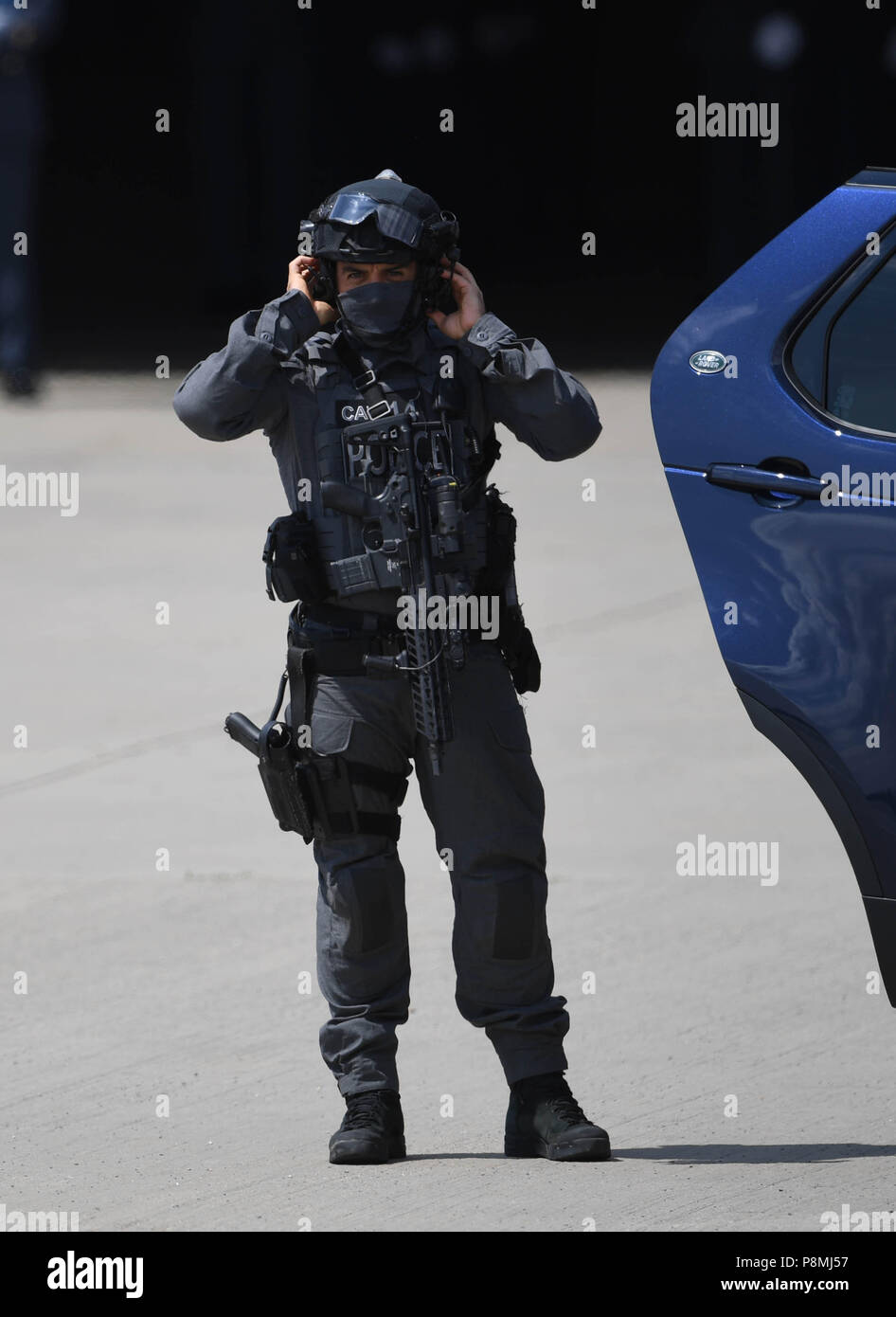 Metropolitan Police Counter Terrorist Specialist Firearms Officer on the tarmac ahead of the the arrival of US President Trump and Melania Trump at Stansted Airport, London for their first official visit to the UK. Stock Photo
