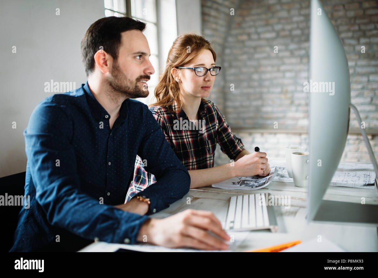 Young architects working on project in office Stock Photo