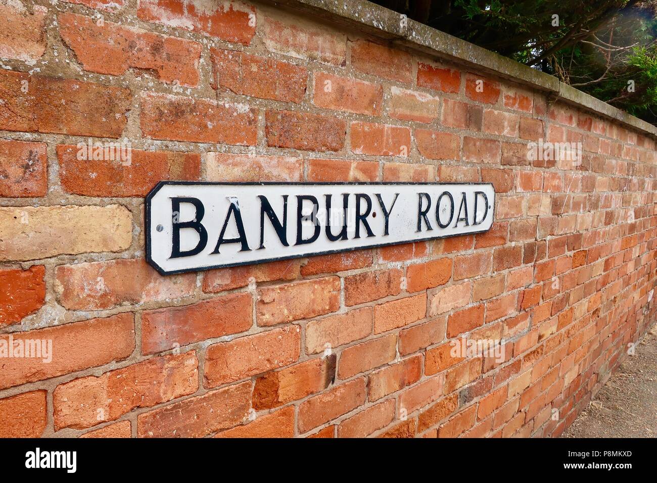 Banbury Road - sign on a red brick wall in Kineton, Warks. Stock Photo