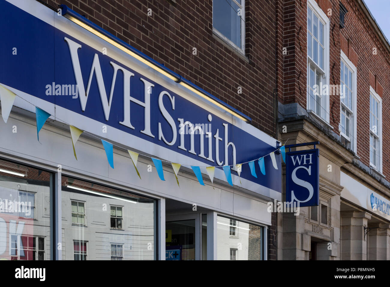 Sign for WH Smith newsagents, Market Square, Thirsk, North Yorkshire, UK Stock Photo
