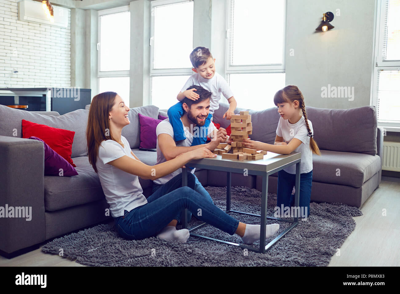 Happy family playing board games at home.  Stock Photo