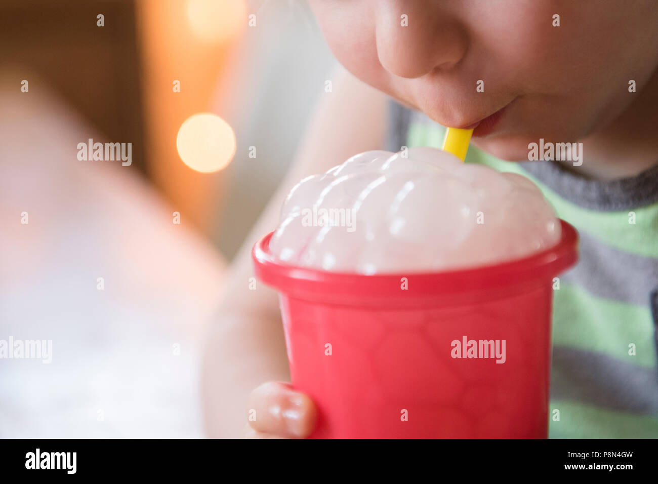 Boy blowing bubbles in drink Stock Photo