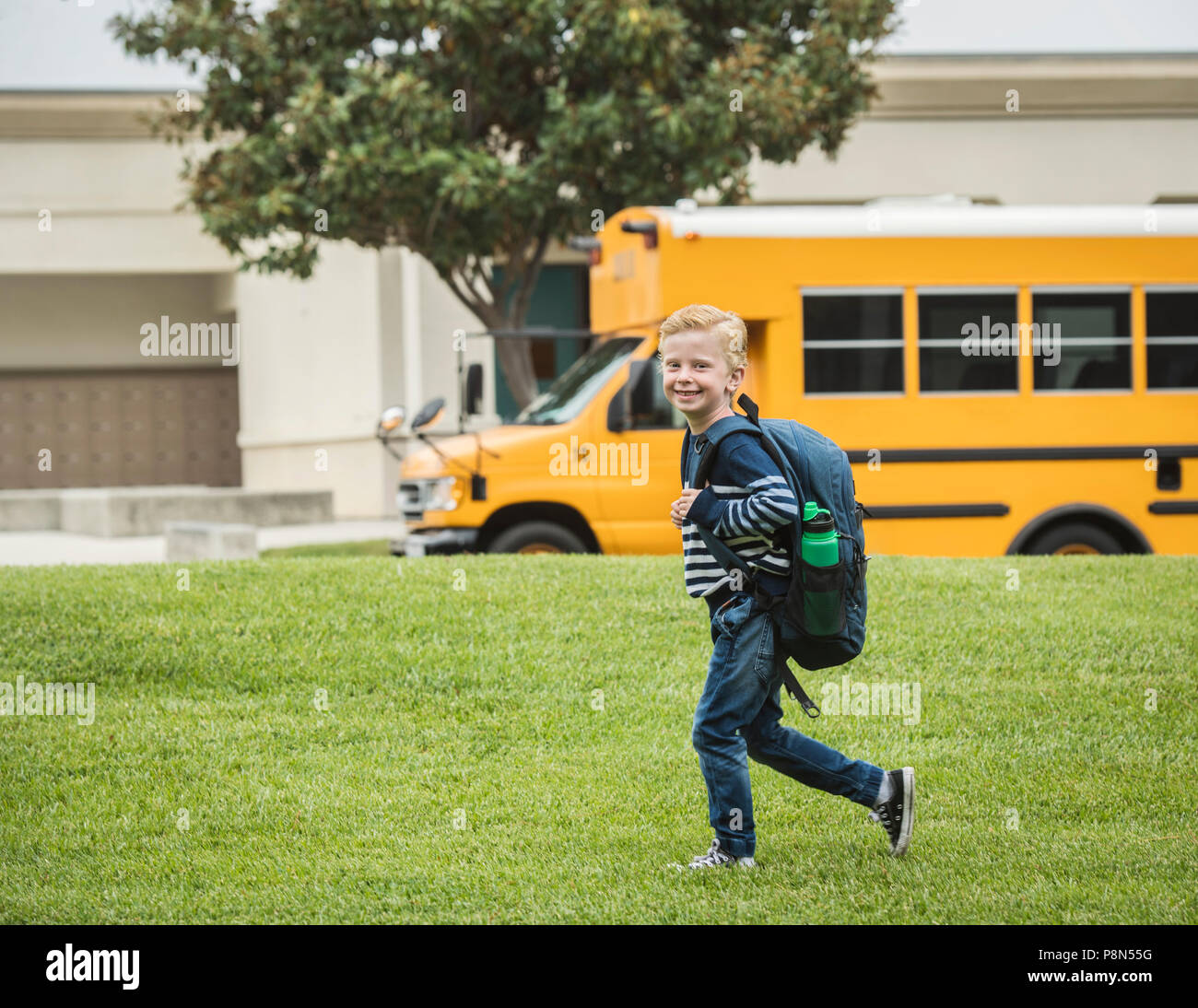 Boy with backpack at school Stock Photo