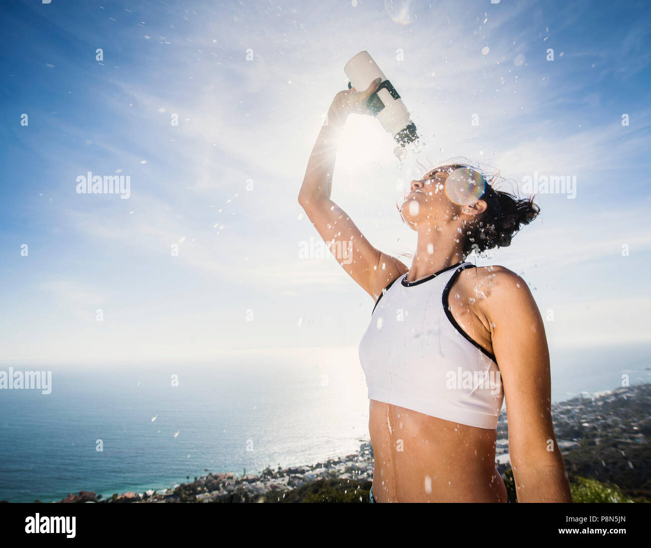Woman pouring water on her head Stock Photo Alamy