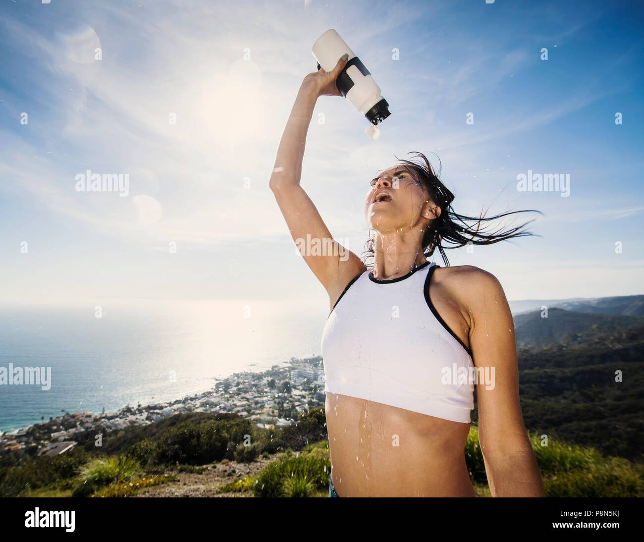 Woman pouring water on her head Stock Photo Alamy