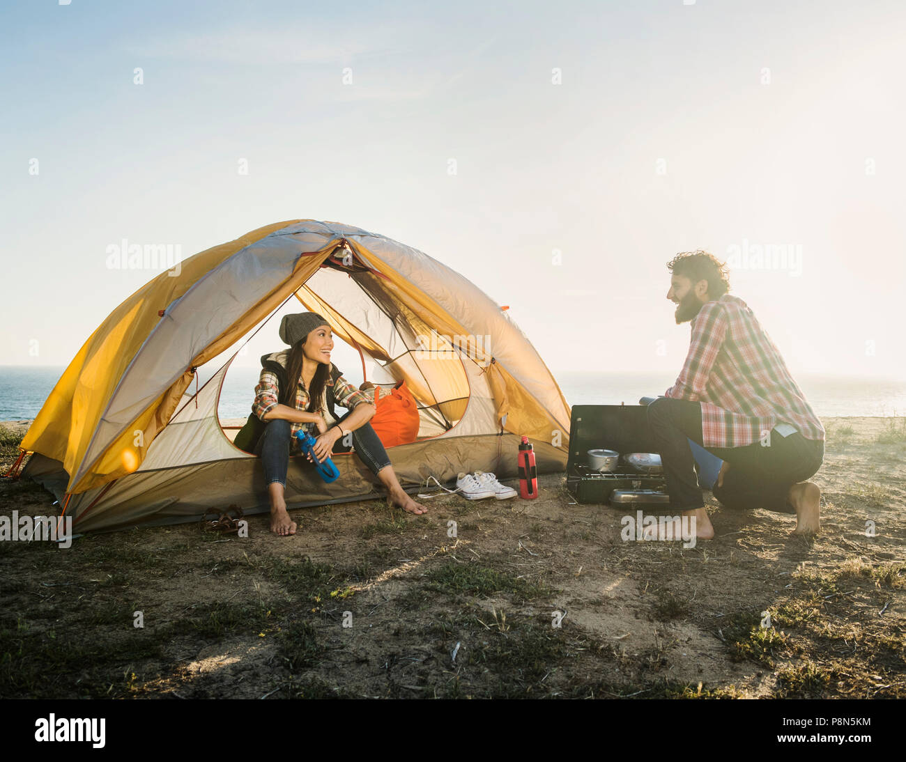 Couple camping on beach Stock Photo