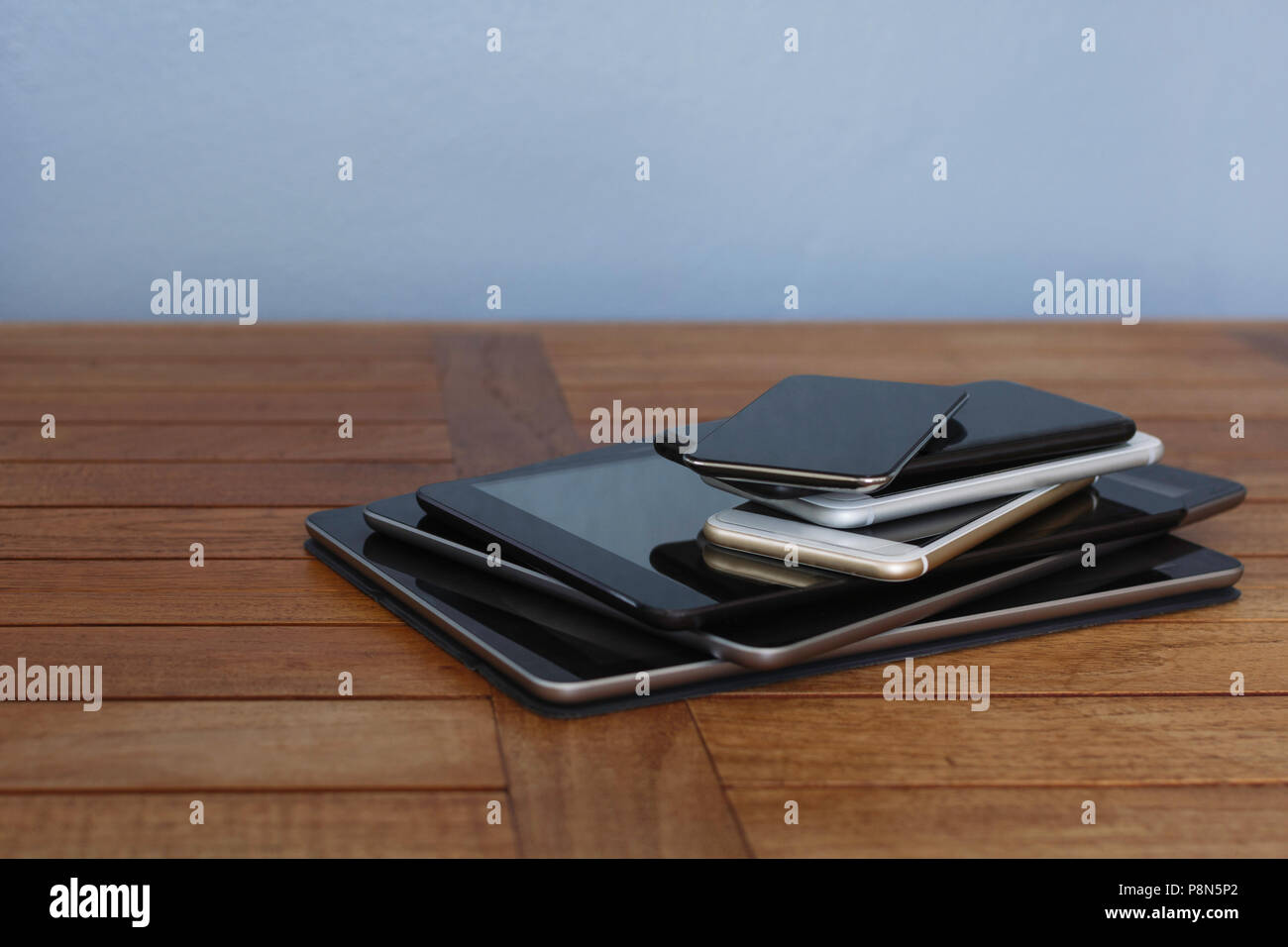 Stack of smart phones and digital tablets Stock Photo
