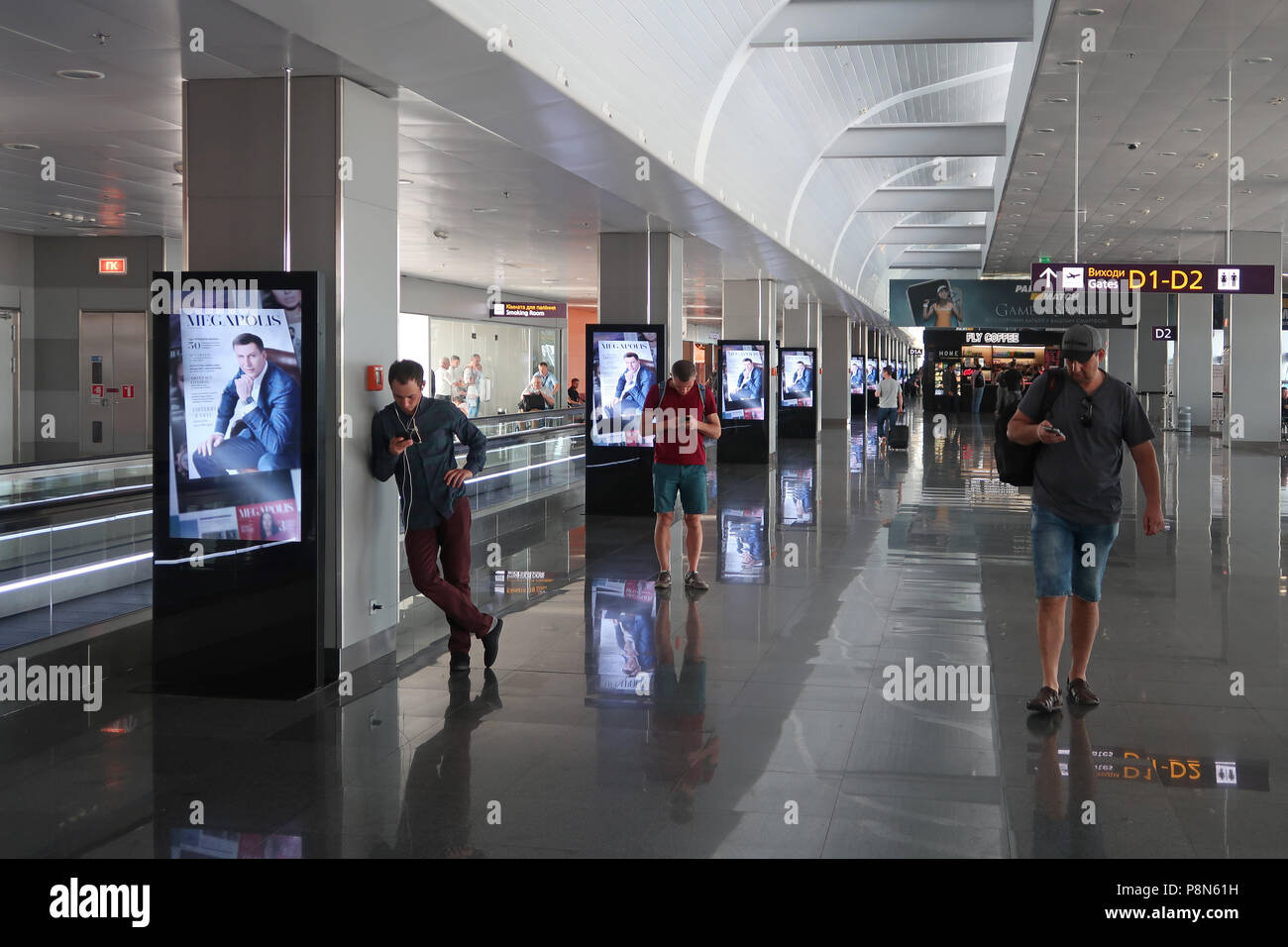 Travelers using their cellular phones at Boryspil International Airport east of Kiev capital of Ukraine Stock Photo