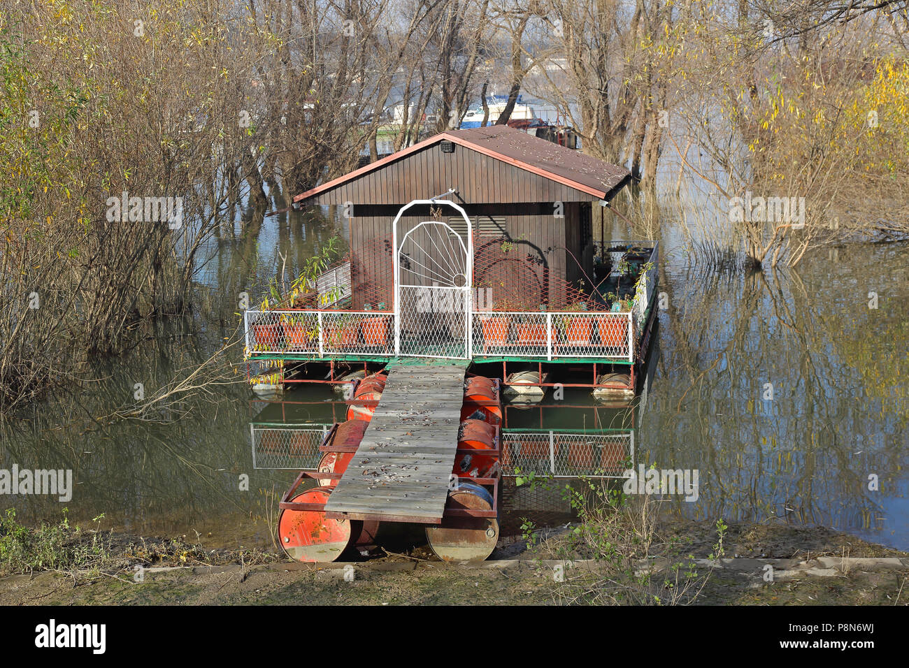 Small Shack Cabin Floating at River Stock Photo