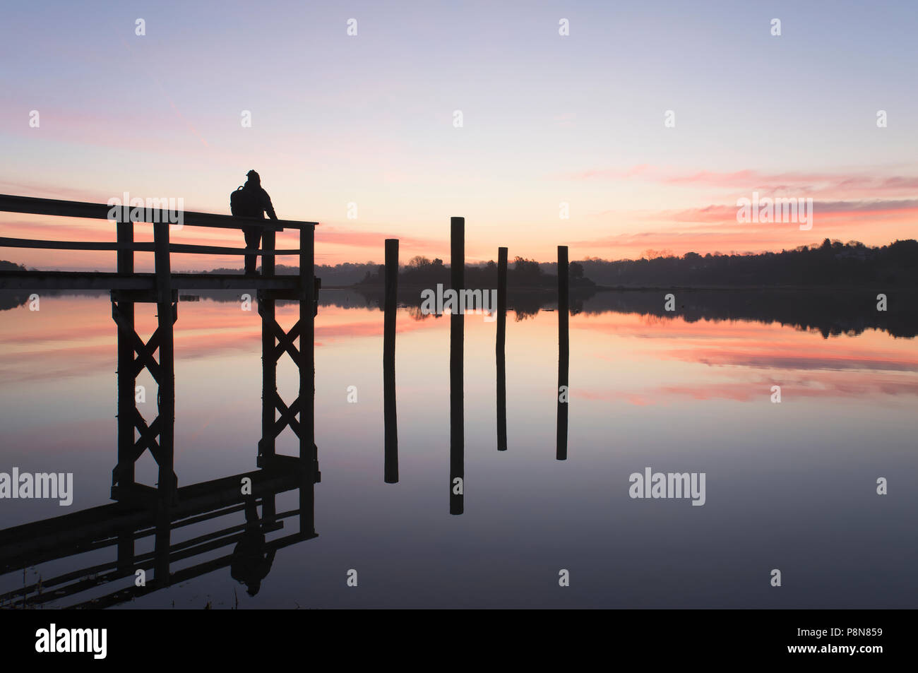 SILHOUETTE ON MAN ON JETTY AT DAWN, CAPE COD, MA, USA Stock Photo