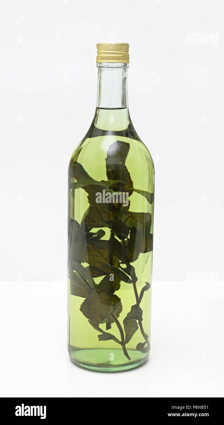 Fruit brandy with medical herbs in bottle Stock Photo Alamy