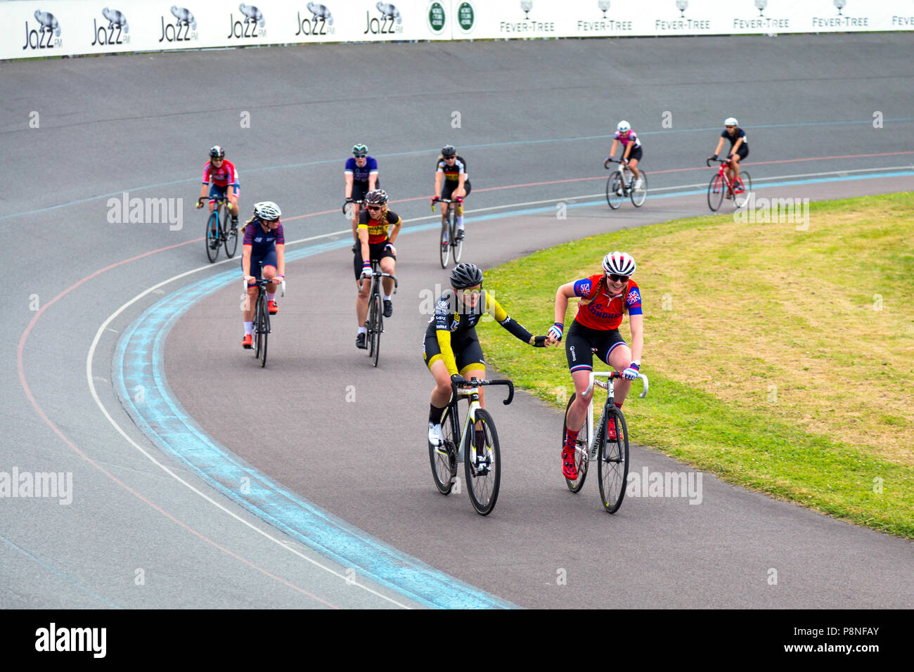 Cyclists holding hands after a race at the Herne Hill velodrome, World Cycling Revival Festival 2018, London, UK Stock Photo