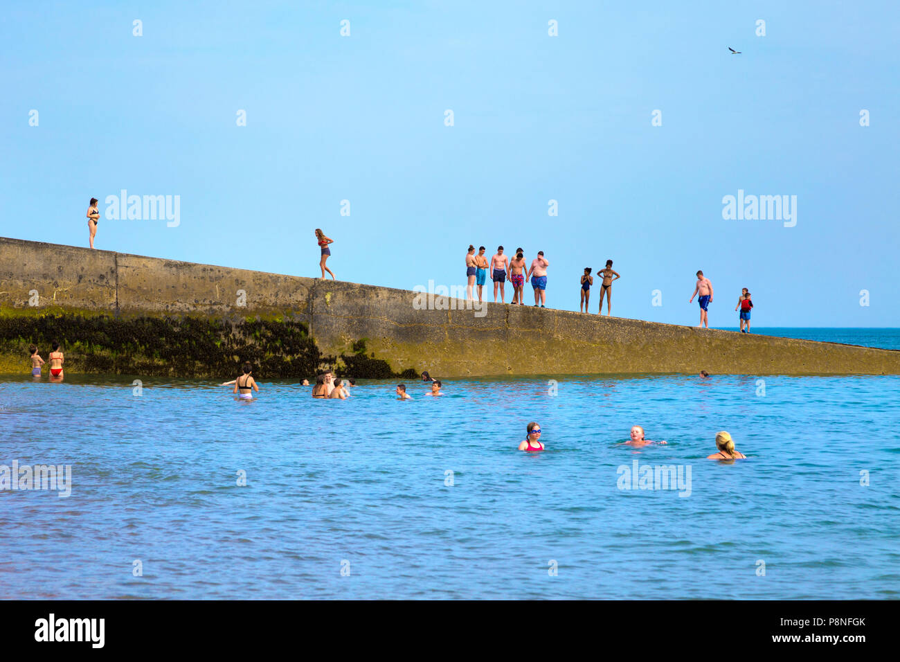 People bathing in the sea in Saltdean, UK Stock Photo