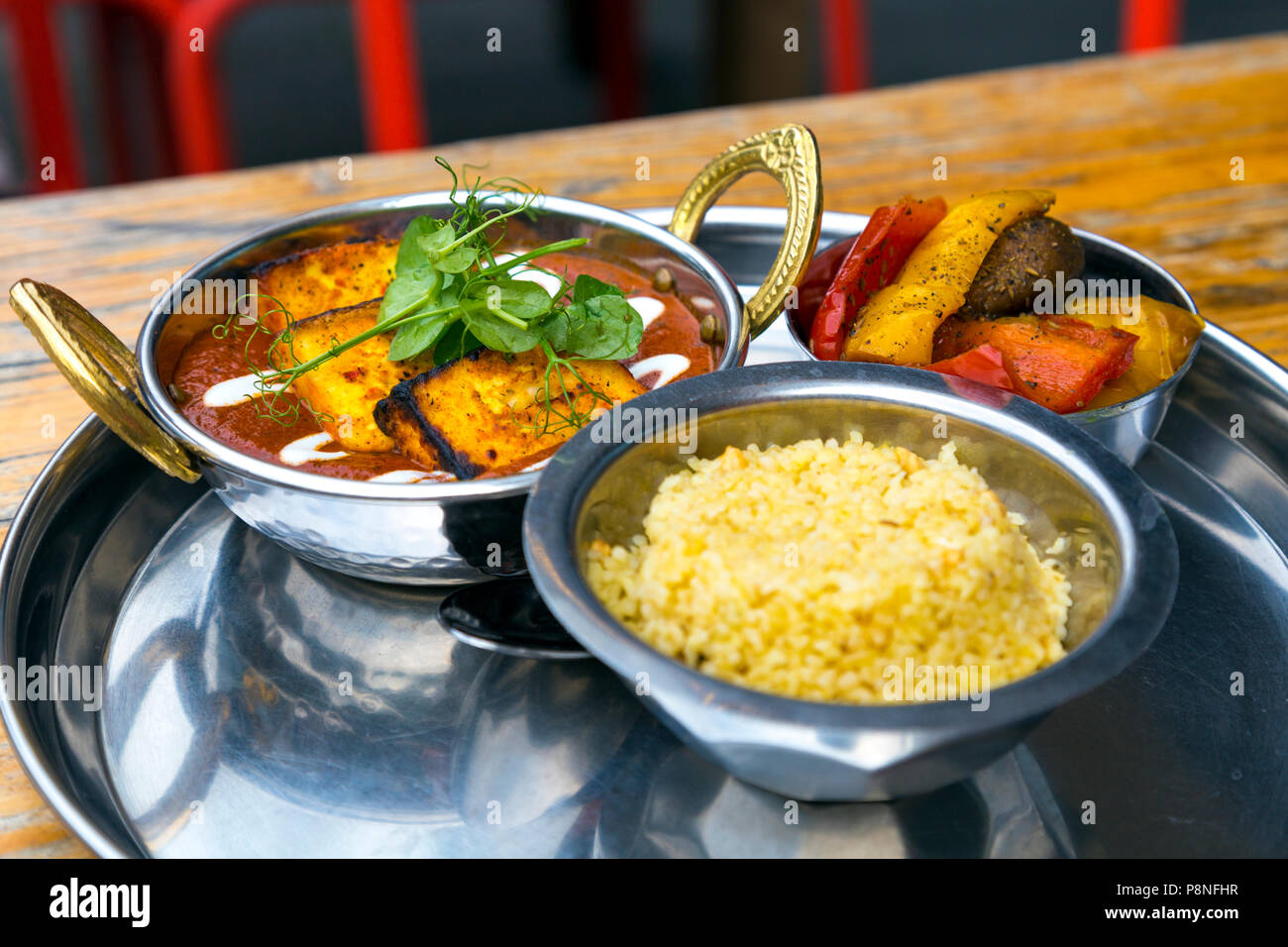 Indian paneer dish with rice and roasted vegetables at a restaurant (The Chilli Pickle in Brighton, UK) Stock Photo