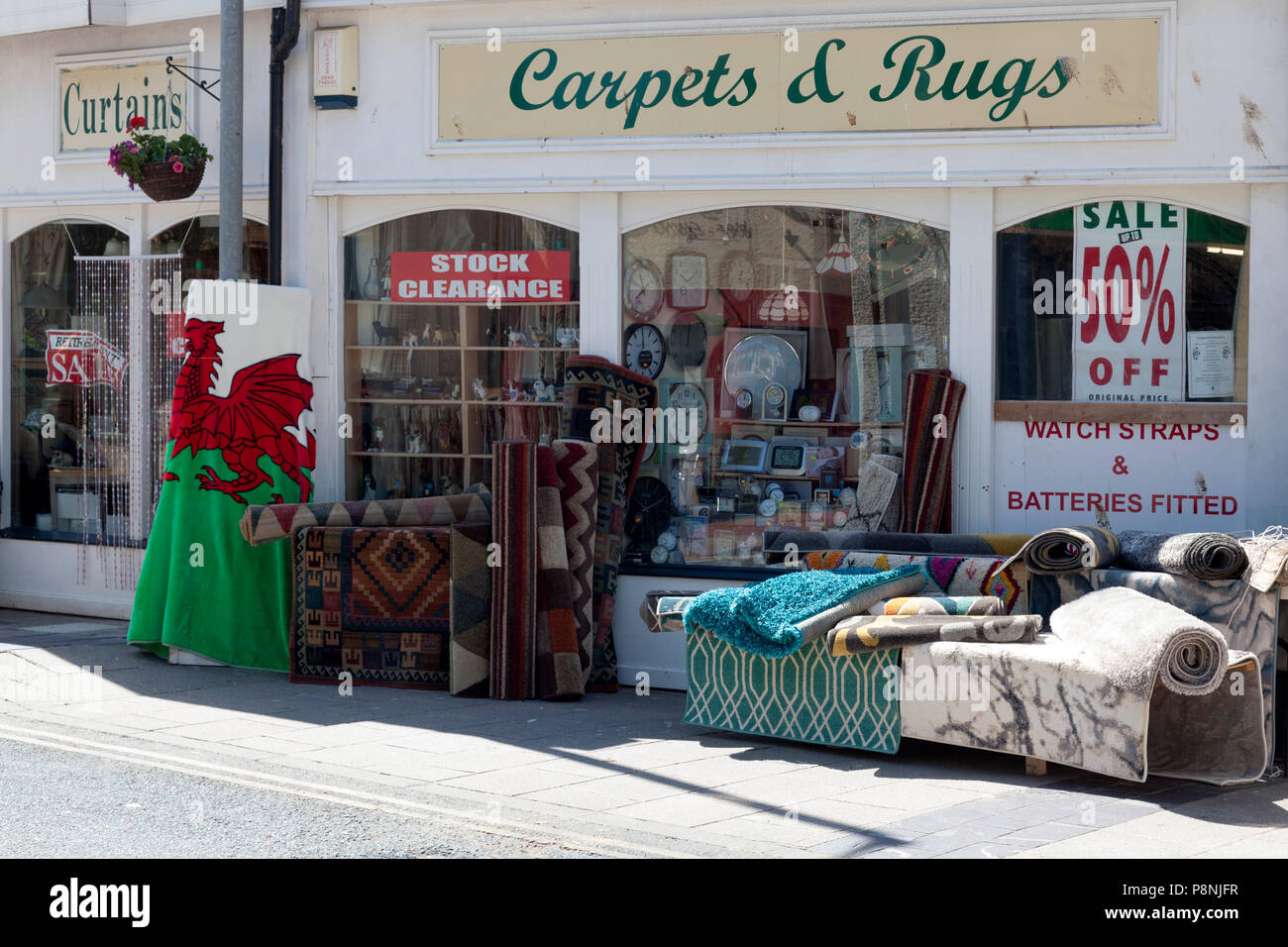 Carpets outside carpet shop, Caernarfon, Gwynedd, Wales Stock Photo