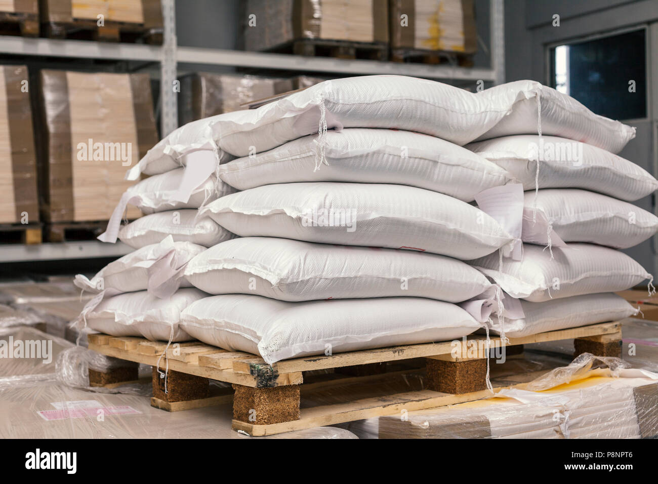 sacks of flour on pallets in warehous Stock Photo Alamy