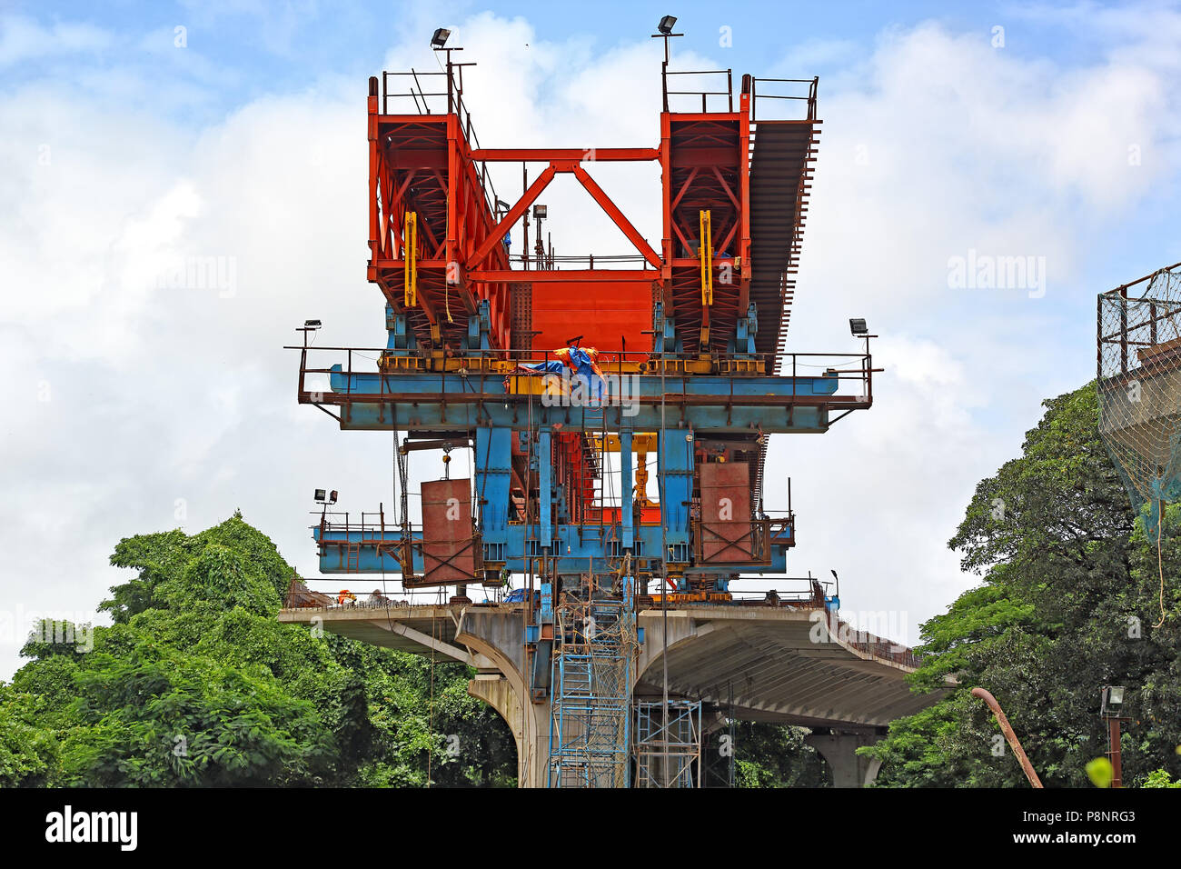 Huge machinery for placing precast concrete segments over columns for the deck of elevated road, part of third bridge across Mandovi River in Goa Stock Photo