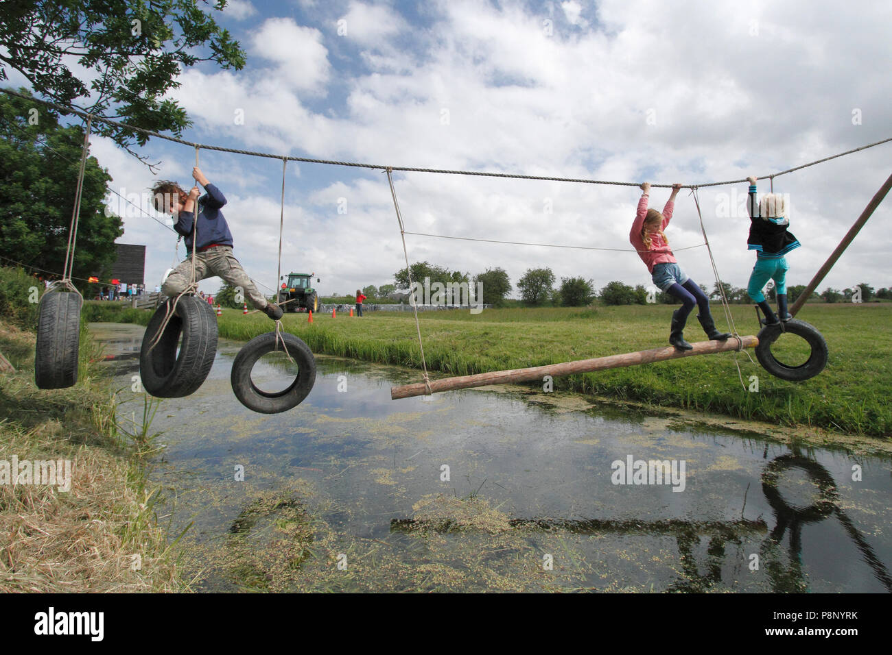 Kids playing outside with a rope Stock Photo - Alamy