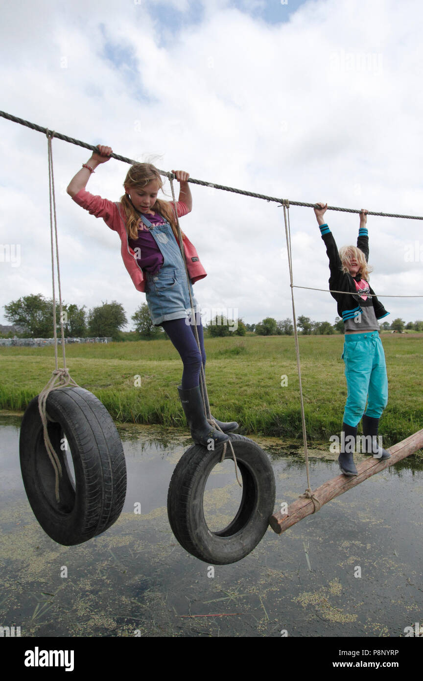 Kids playing outside with a rope Stock Photo