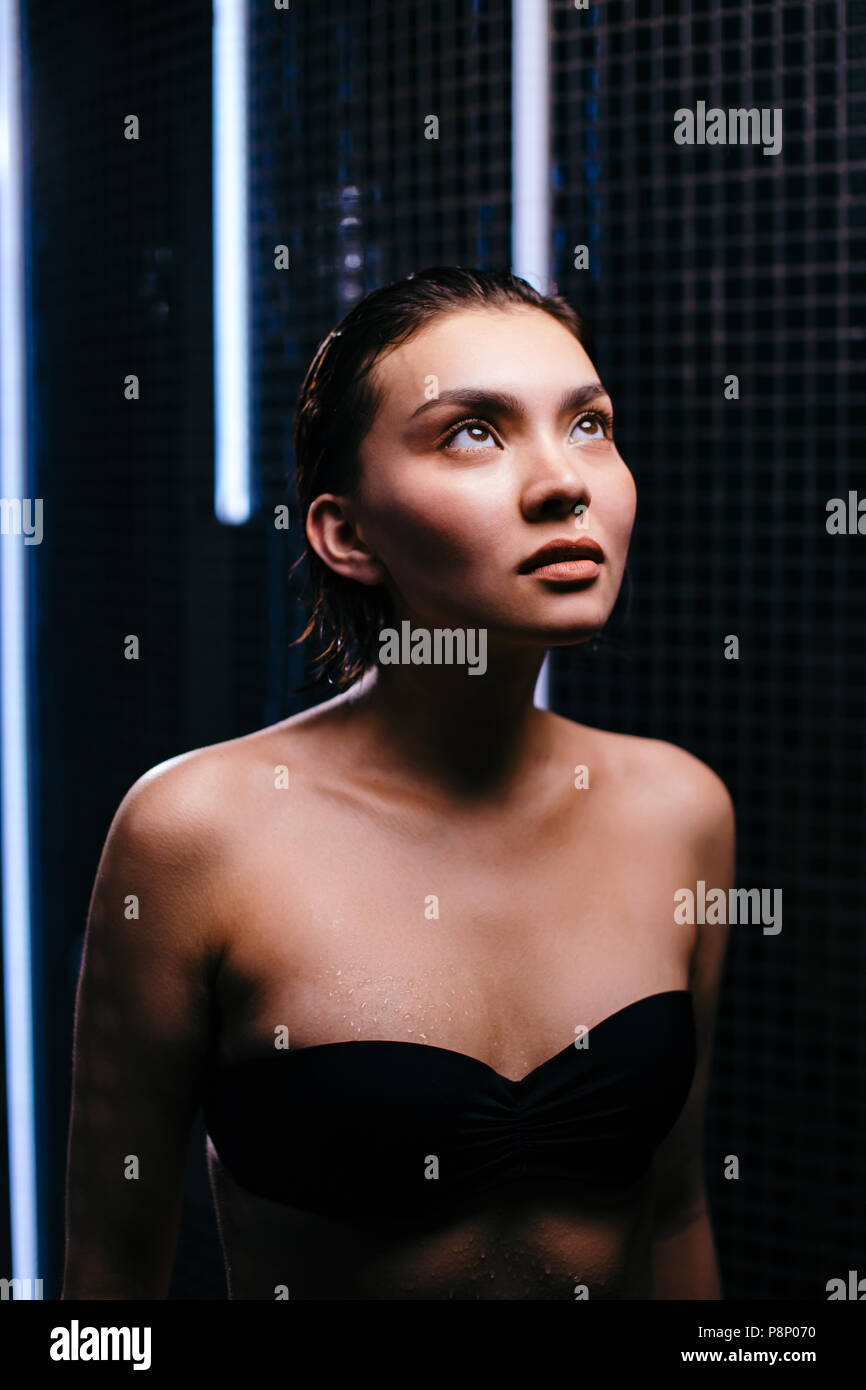 close up photo. asian girl is afraid of taking a shower in the shower