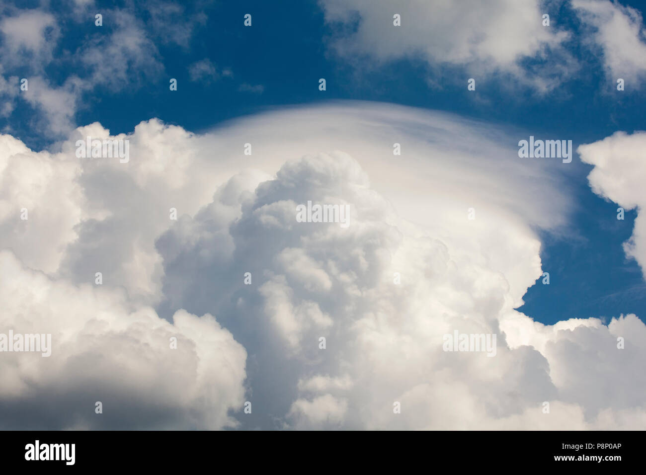 Pileus, also called scarf cloud or cap cloud, above a cumulus cloud Stock Photo