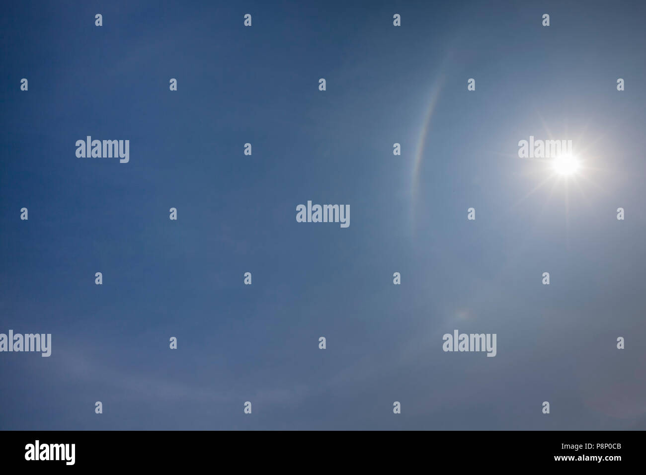 Parhelic circle, sun dog and upper tangent arc surrounding the sun Stock Photo
