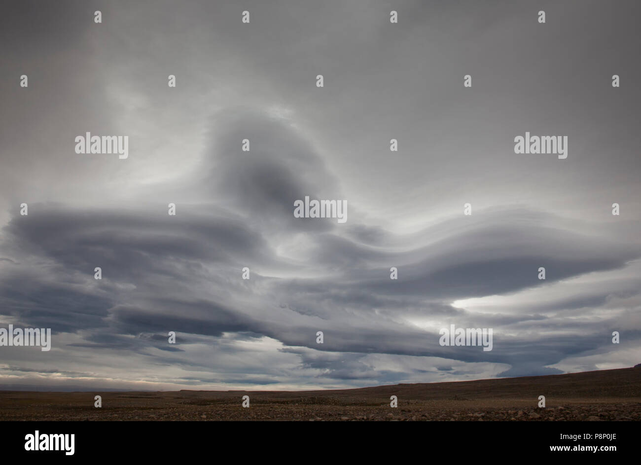 Altocumulus lenticularis clouds above the mountains in Iceland Stock Photo