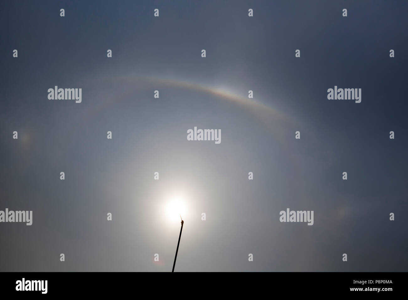 Parhelic circle, sun dogs and upper tangent arc surrounding the sun Stock Photo
