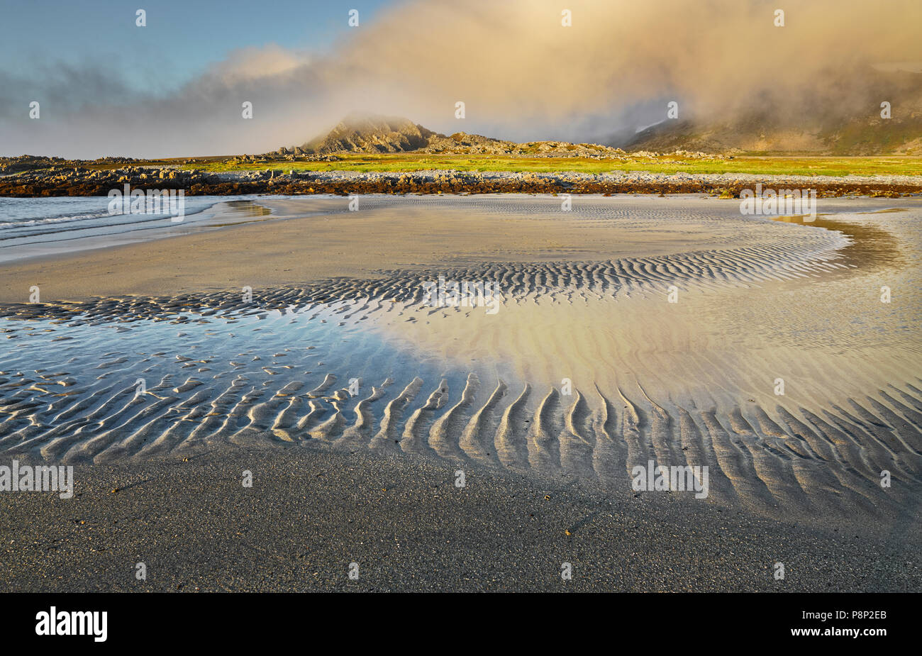 Beach at low tide in Northern Norway under midnight sun Stock Photo