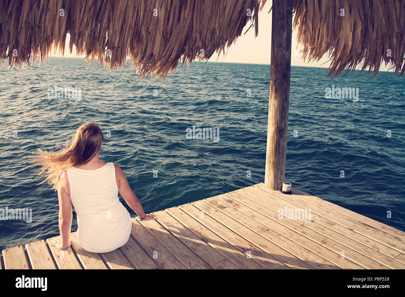 Woman in white dress sits hi-res stock photography and images - Alamy