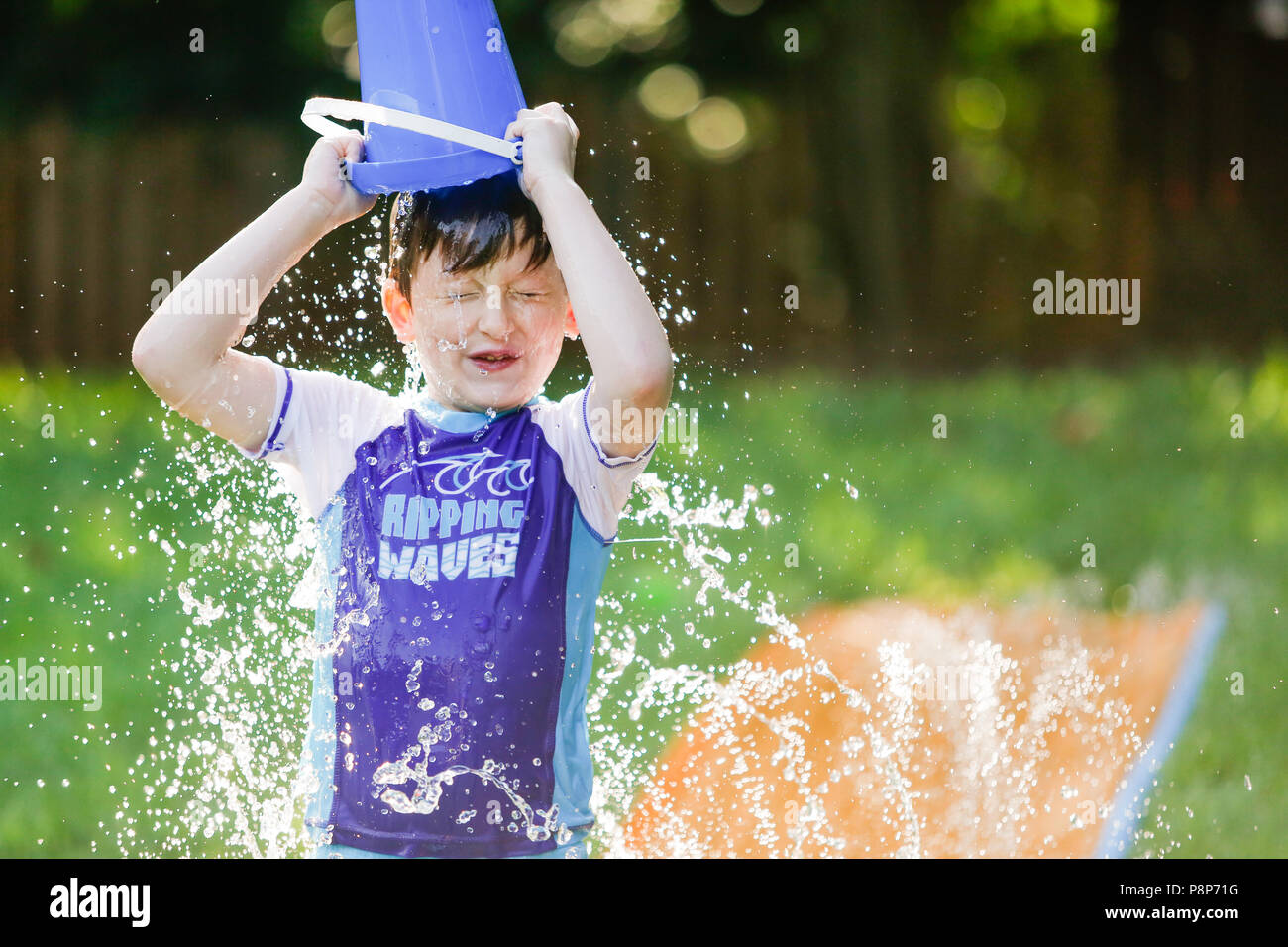 Bucket of water pouring head hires stock photography and images Alamy