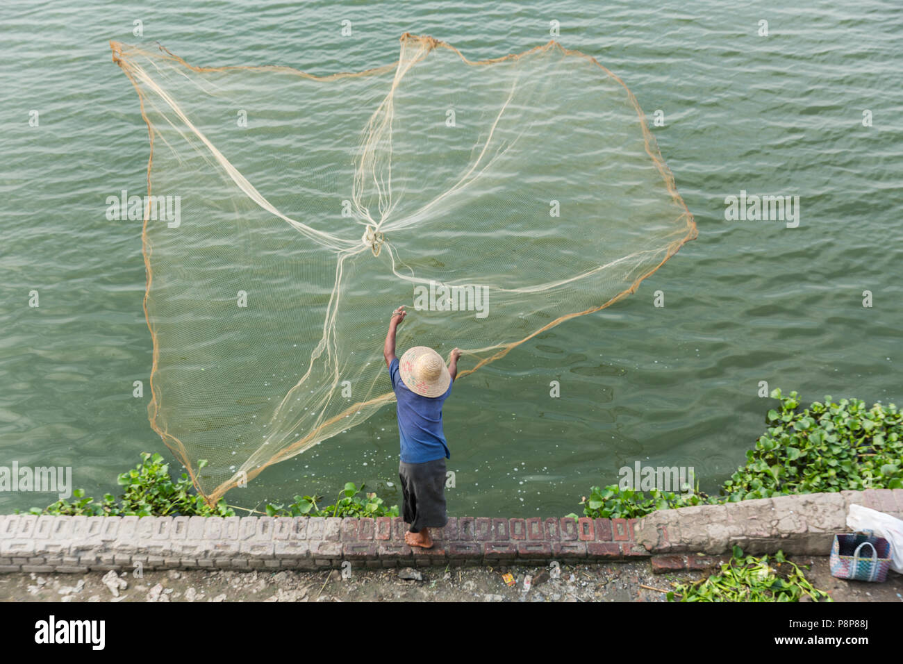Fisherman casting net at U Bein Bridge Stock Photo