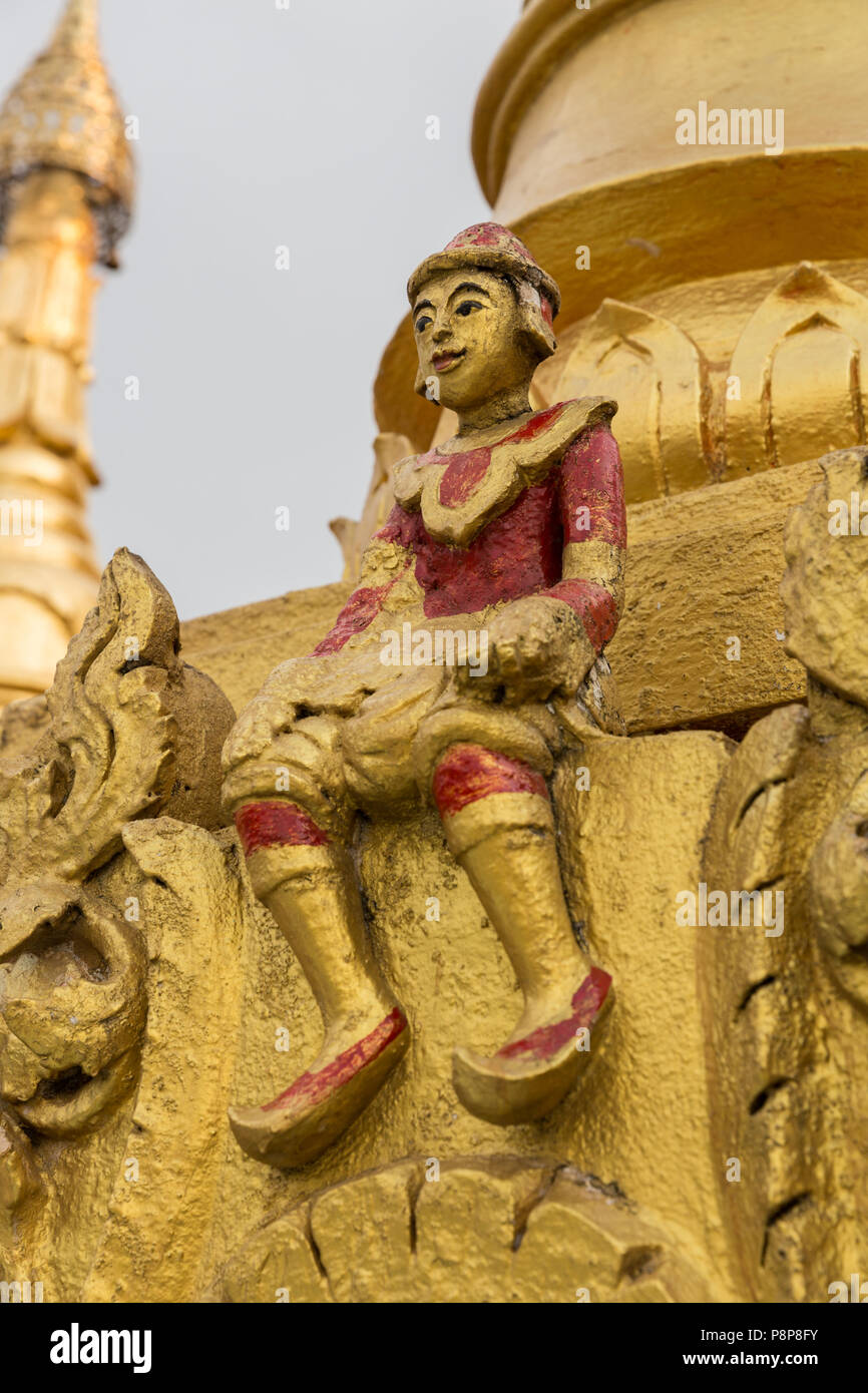 Red and gold Sitting figurine at Mount Popa Monastery, Myanmar (Burma) Stock Photo