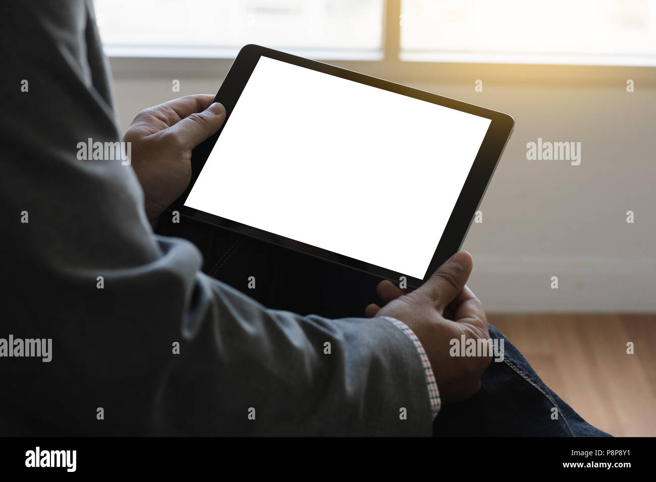 Digital tablet computer close up man using tablet hands man multitasking with isolated screen Stock Photo