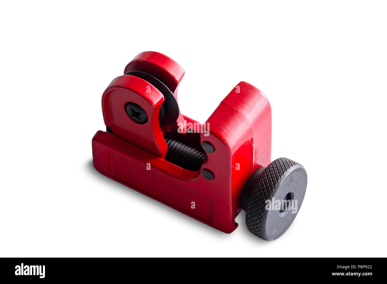 Isolated red metal pipe cutter for cutting lengths of tubing for plumbing standing diagonally on white with copy space Stock Photo