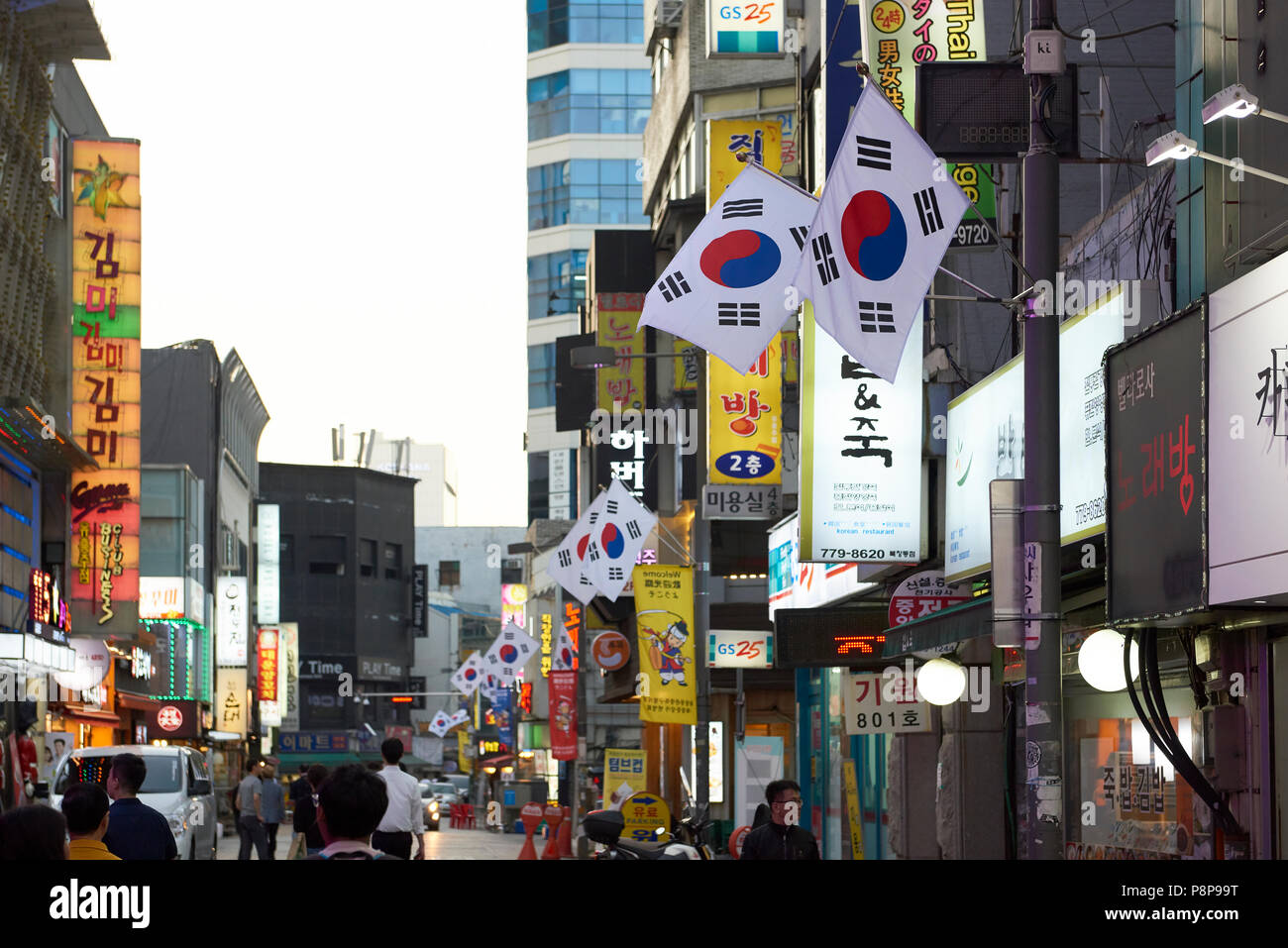 Commercial street in Seoul, South Korea, with row of South Korean flags. Stock Photo