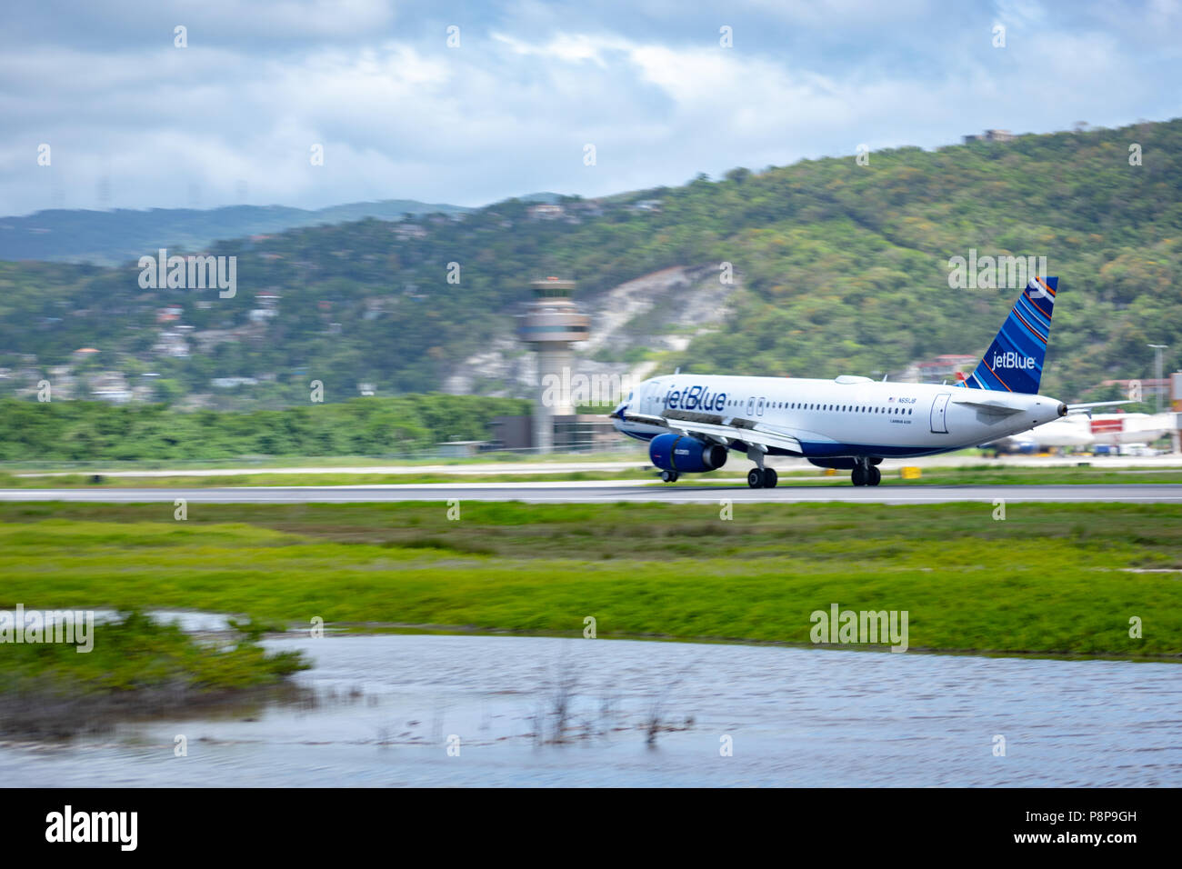 Montego Bay, Jamaica - April 11 2015: JetBlue aircraft on the runway at Sangster International Airport (MBJ) in Montego Bay, Jamaica. Stock Photo