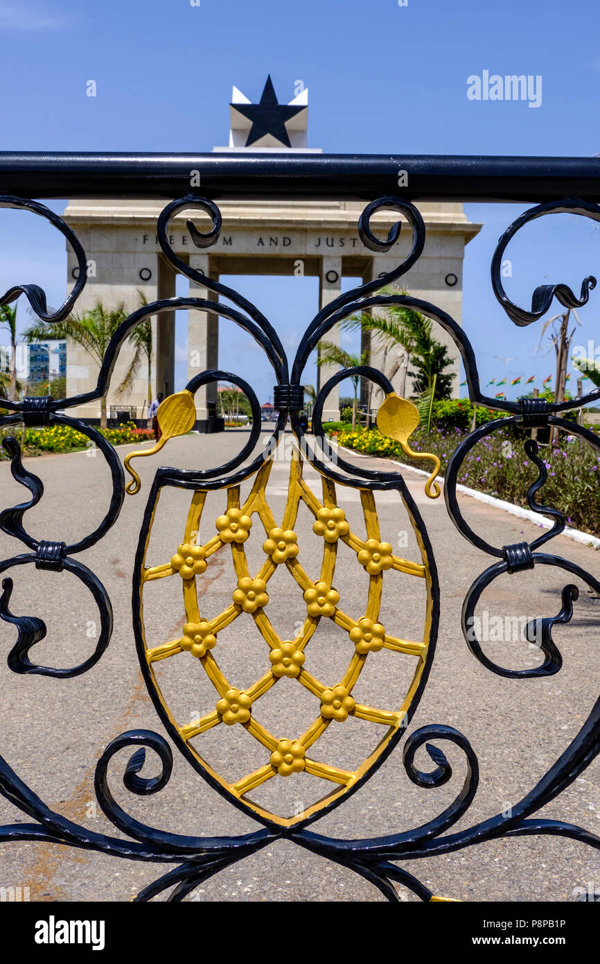 Looking through ornate railings to Black Star Monument in Independence Square Accra Ghana against blue sky Stock Photo