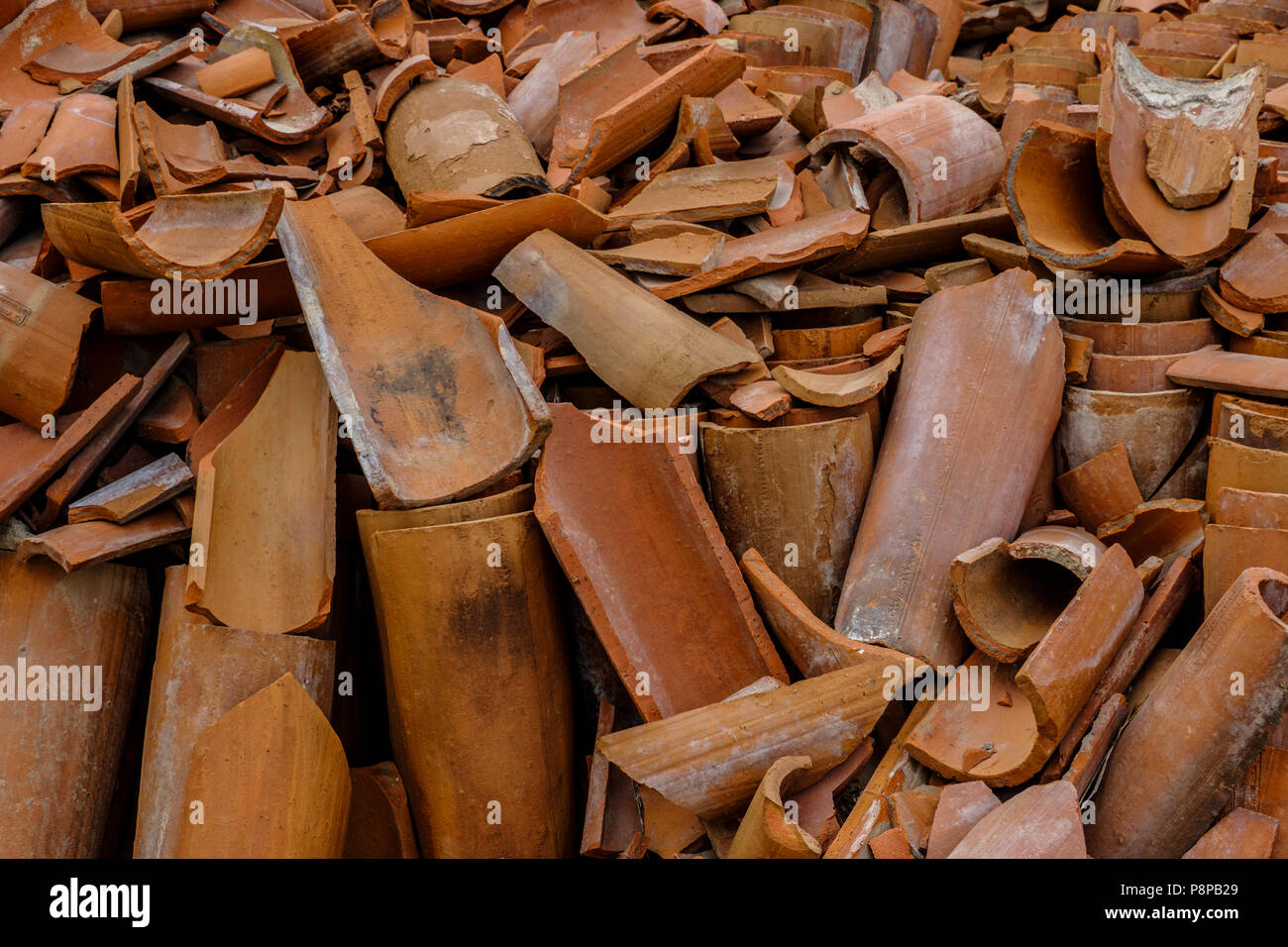 Pile of broken terracotta clay pipes provide interesting textured background Stock Photo