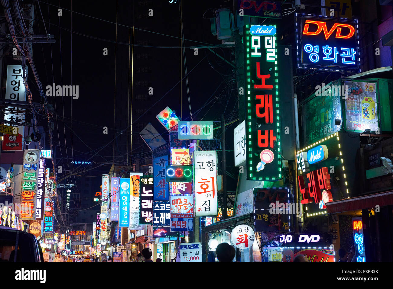 Yeongdeungpodong street at night in Seoul, South Korea, cluttered with shop signs lighting. The area is known for its nightlife. Stock Photo